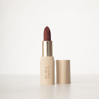 A matte lipstick in a bullet container, with the brand name 'RUFA' inscribed on it. The color of the lipstick is brown.
